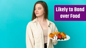 Teenager girl holding waffles over isolated blue background looking to the side.