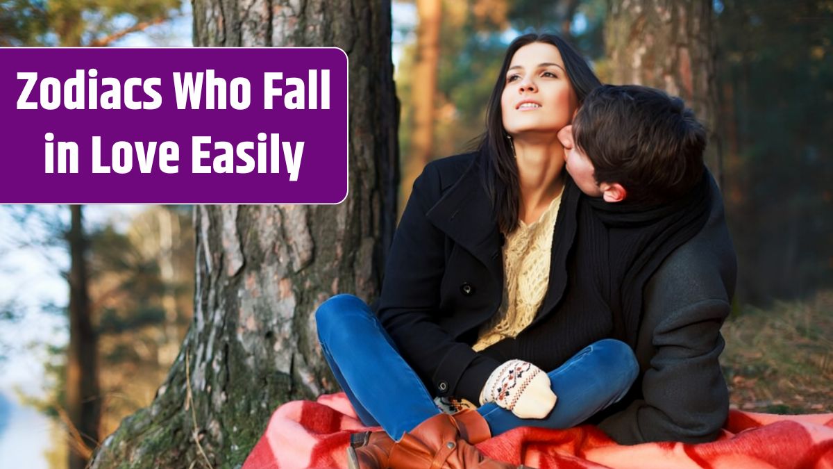 Couple sitting next to a tree in the forest.