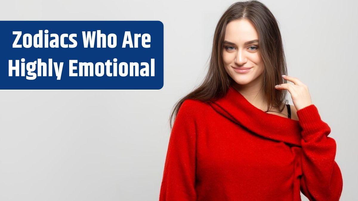 Portrait of a young beautiful woman with a light smile dressed in a red sweater on a light gray background.